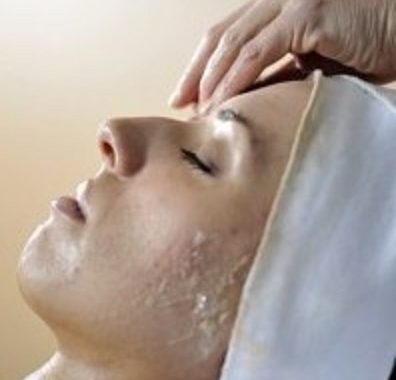 Image of a client getting her face washed
