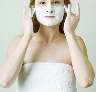 Picture of a woman with a white cream facial mask on