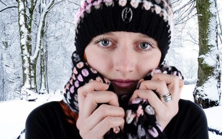 Image of a woman bundled up in hat and scarf in the winter
