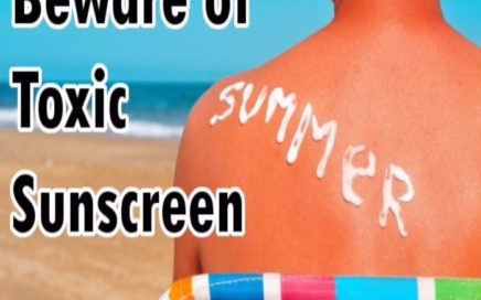 Image of a bare backed person sitting at the beach with the words "Beware of toxic sunscreen"