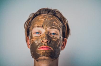 Image of a woman with a clay mask on