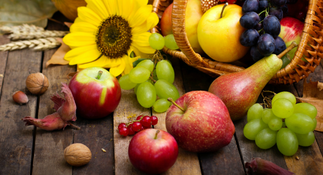 Image of a bsket with Fall harvest fruit and flower
