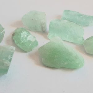 Image of eight raw Green Calcite Crystals
