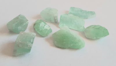 Image of eight raw Green Calcite Crystals