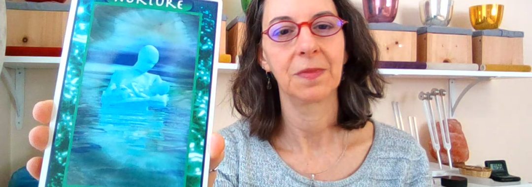 Image of Saralee holding the Crystal Tarot Card for March 2021, Nurture - Larimar