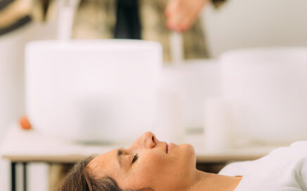 Woman lying down during crystal bowl healing session