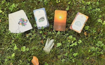 tarot cards and crystal on grass