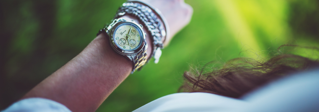 Image of woman looking at the time on her watch