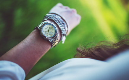 Image of woman looking at the time on her watch